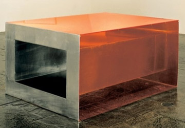 A escultura Sem título, de Donald Judd, de 1968, possui o formato de uma grande caixa retangular, posicionada no chão da galeria. A peça é feita com materiais industriais, tais como aço e acrílico em tom laranja. Dependendo do ângulo em que se observa a obra, temos impressões diferentes sobre ela. Se observada de cima ou de lado, vemos, através do acrílico alaranjado, as formas de uma caixa de aço. A transparência do acrílico nos dá a impressão de que a caixa de aço está flutuando sobre o chão, refletindo o alaranjado do acrílico no ambiente ao redor. Se observada de frente, vemos o interior da caixa, revelando um grande e profundo espaço vazio feito de aço. Judd busca provocar uma ilusão em relação ao espaço representado em sua obra. Isso é reforçado com a declaração do artista, em 1965, de que 'O espaço real é intrinsicamente mais poderoso e mais específico do que a tinta sobre uma superfície plana'.